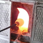 Molten glass is taken from the furnace.
