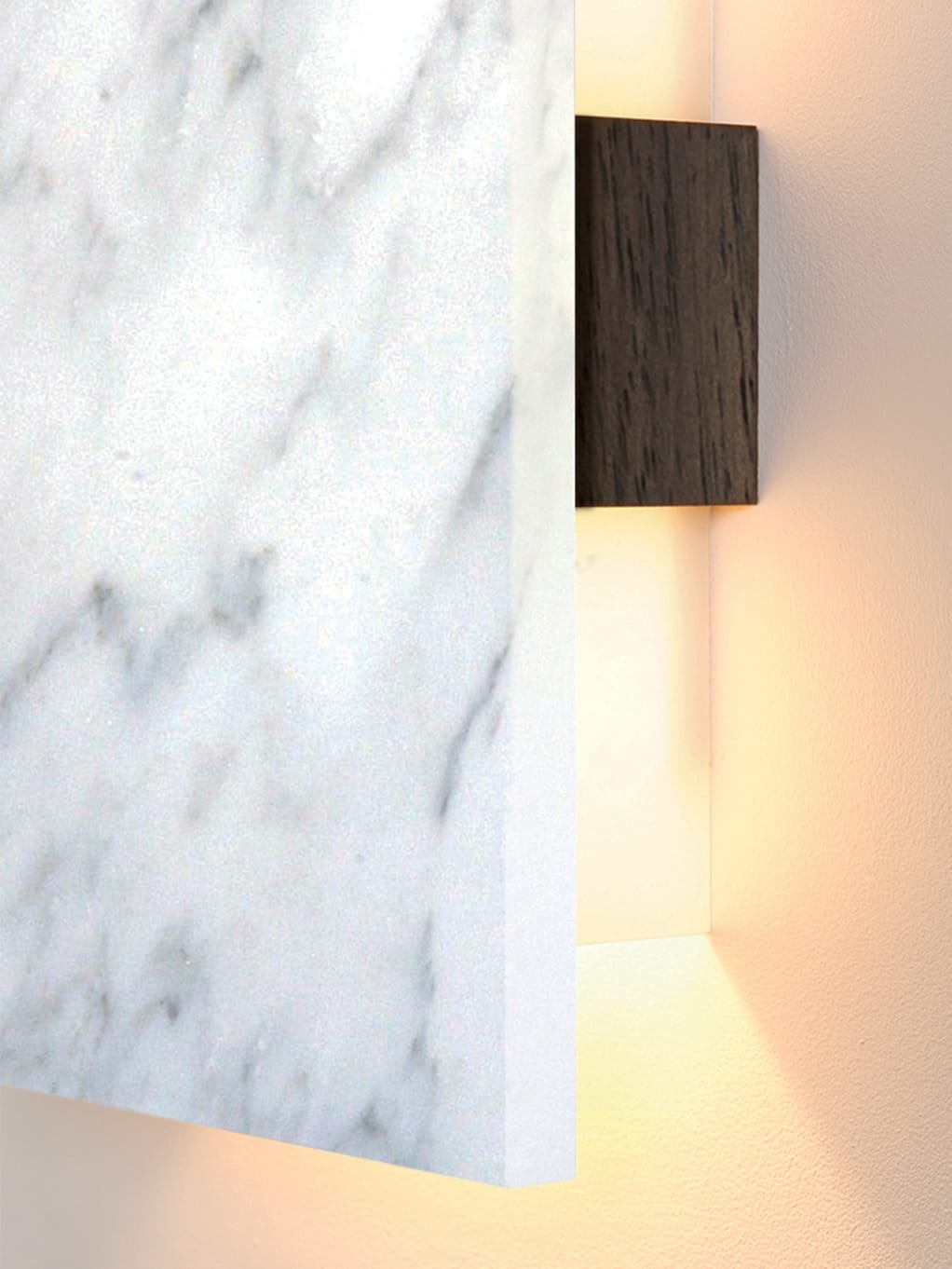 A close-up view of Cerno’s Tersus LED Wall Sconce in Carrara Marble and Walnut.