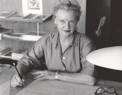 Black and white portrait of Greta Grossman at her desk.