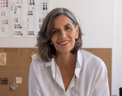 Nani Marquina in her studio holding yarn scraps.