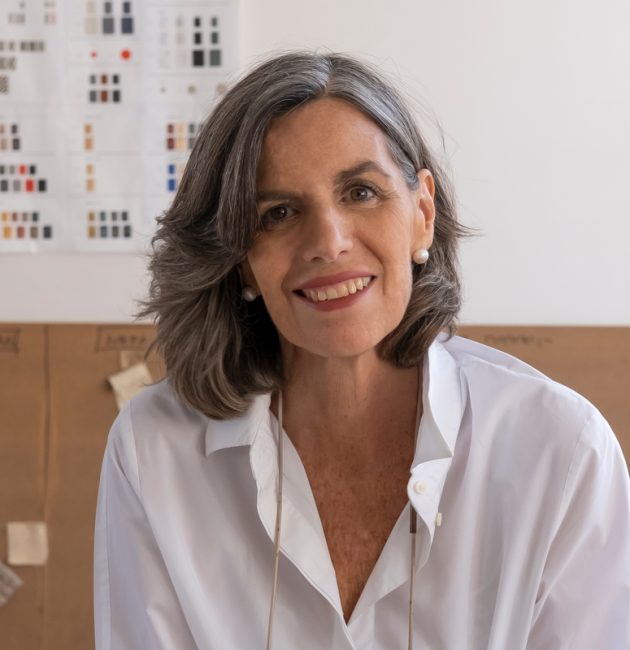 Nani Marquina in her studio holding yarn scraps.